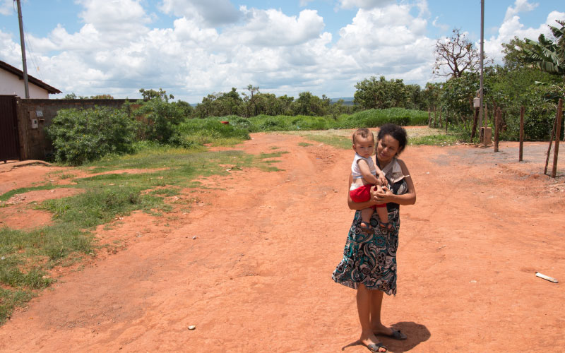 woman and child walking a dirt road